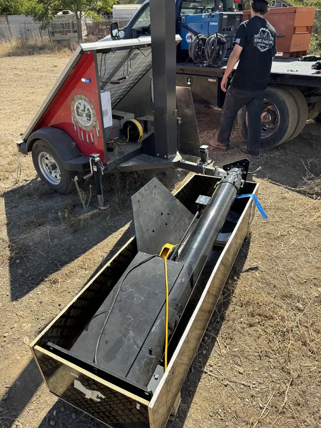 Replacement mast assembly being fitted to a trailer on site