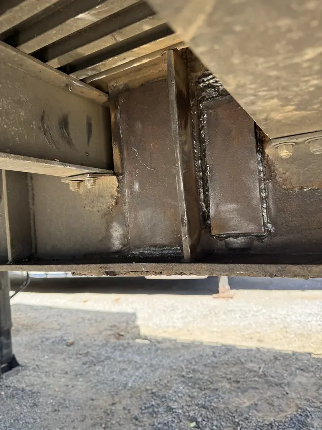 Repaired crossmember-to-beam joints on a semi flatbed