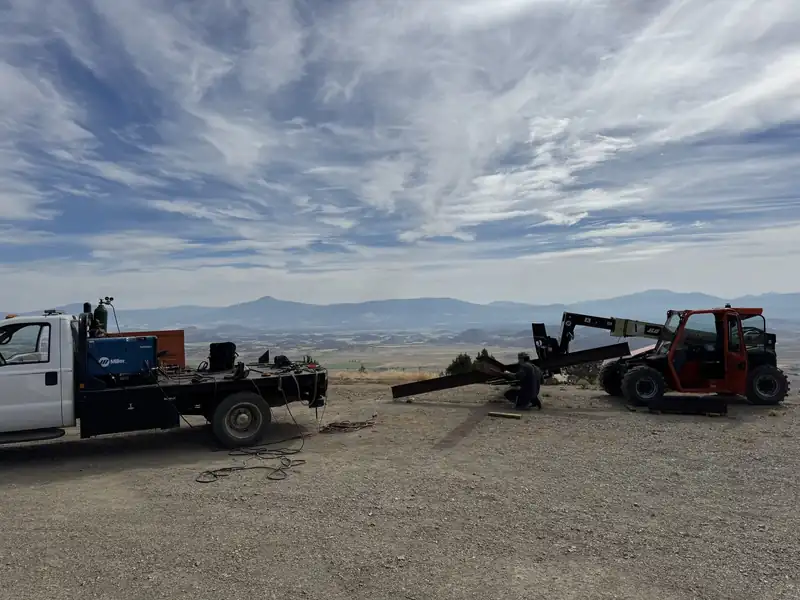 AHT mobile welding rig and telehandler on a job site below Mt. Shasta