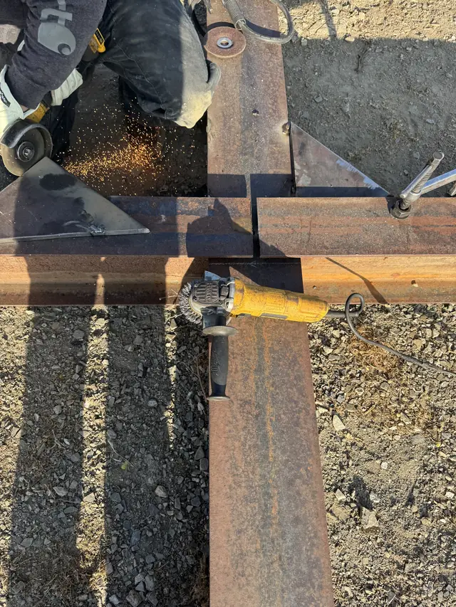 Cutting and grinding a steel joint on a field job