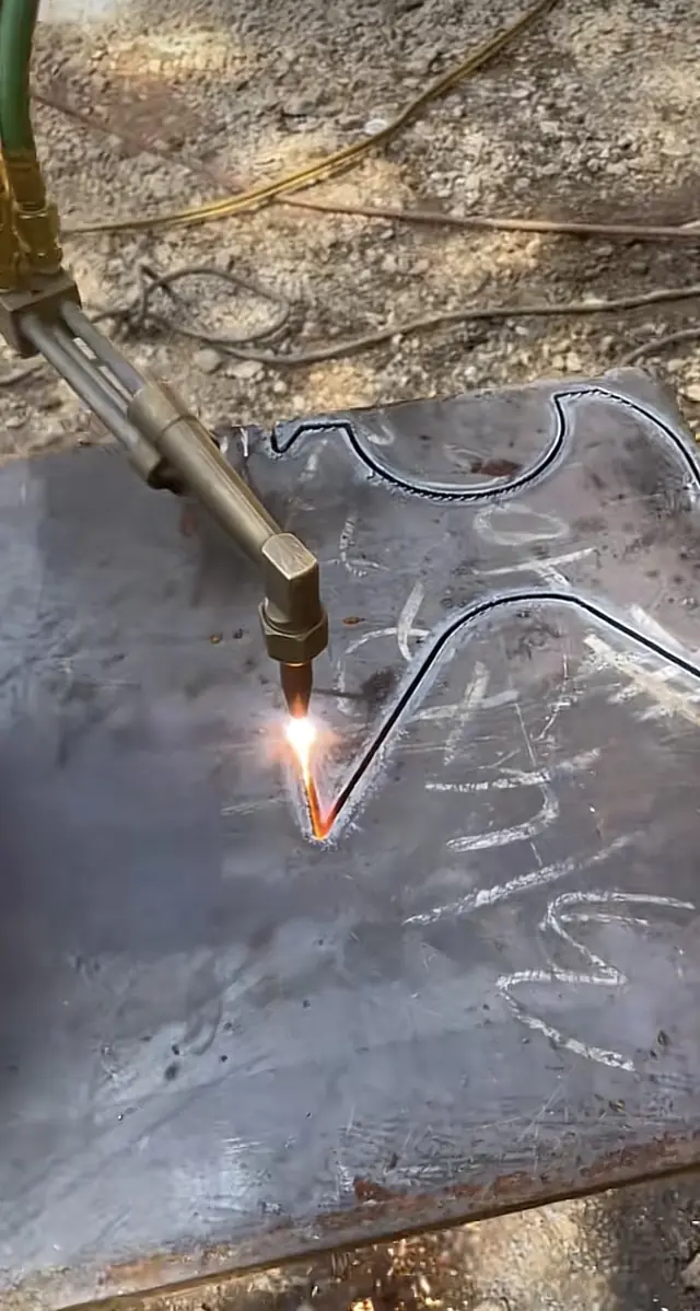 Oxy-fuel torch cutting a pattern in steel plate