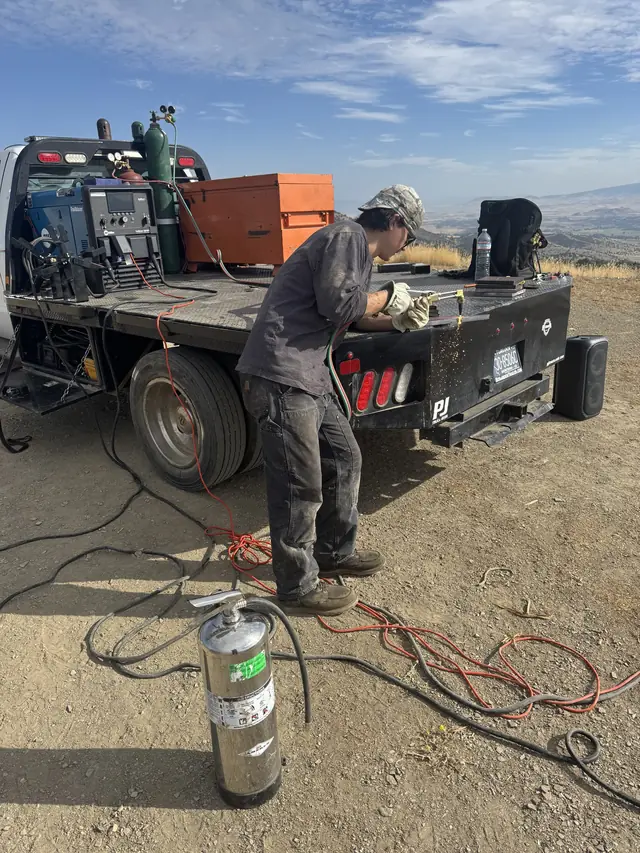 AHT welder working at the mobile rig on a rural Siskiyou County job